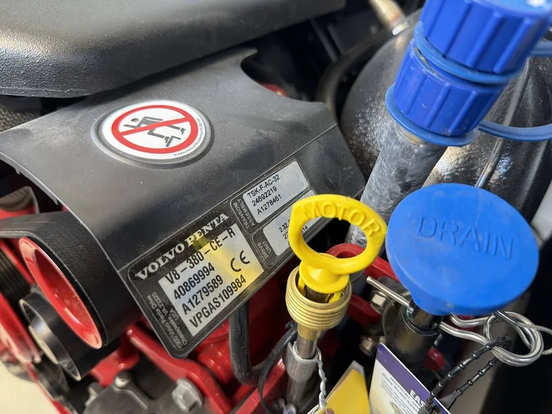 Slide: The Image of Close-up of a Volvo Penta engine with various labels and a yellow oil dipstick. - 18