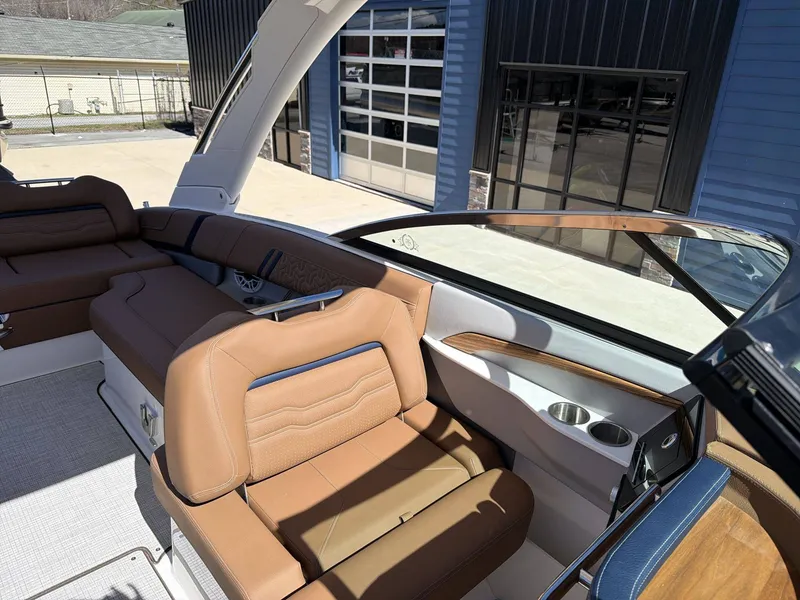 Slide: The Image of The image shows the interior of a 2026 Regal LS9 boat with brown leather seating. - 11