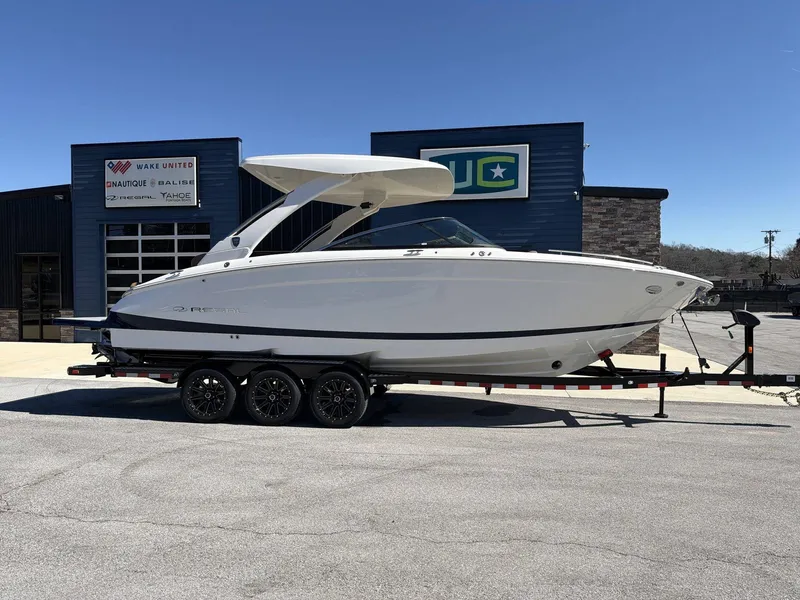 The Image of A 2026 Regal LS9 boat on a trailer in front of a building. - 1