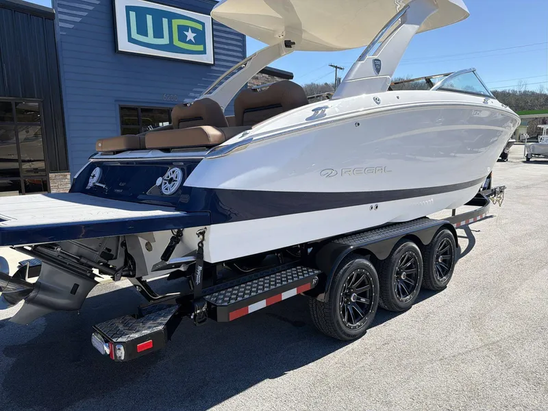 Slide: The Image of Regal LS9 2026: Sleek motorboat with modern design, on a trailer in a marina area. - 25