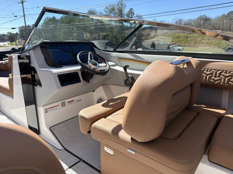 Slide: The Image of The image shows the cockpit of a 2026 Regal LS9 boat with brown leather seats and a modern helm. - 8