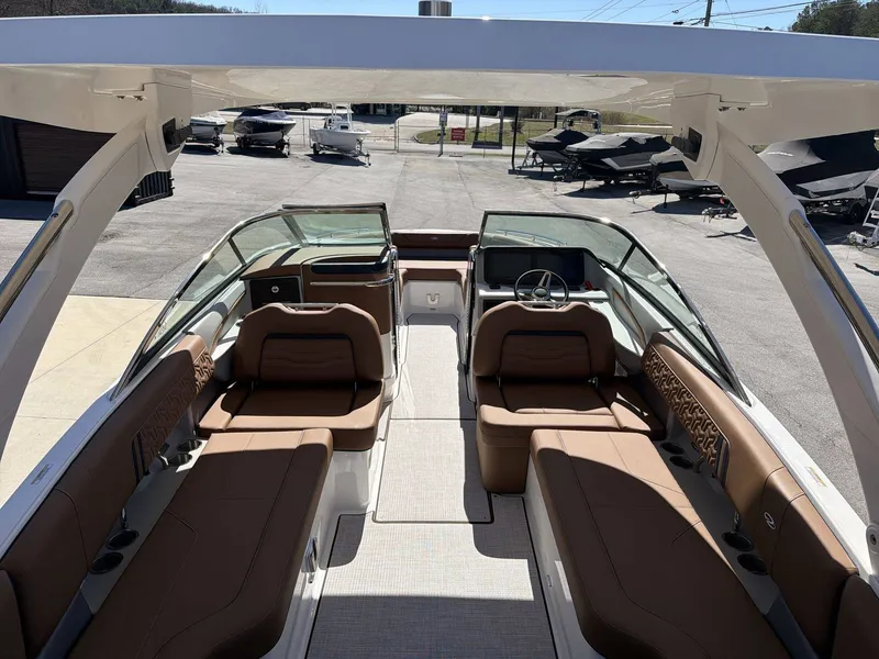 Slide: The Image of The image shows the interior of a 2026 Regal LS9 boat with brown seating and a modern helm. - 14