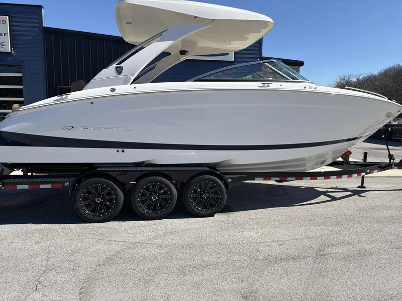 Slide: The Image of A sleek 2026 Regal LS9 boat on a trailer, featuring a modern design and triple-axle chassis. - 17