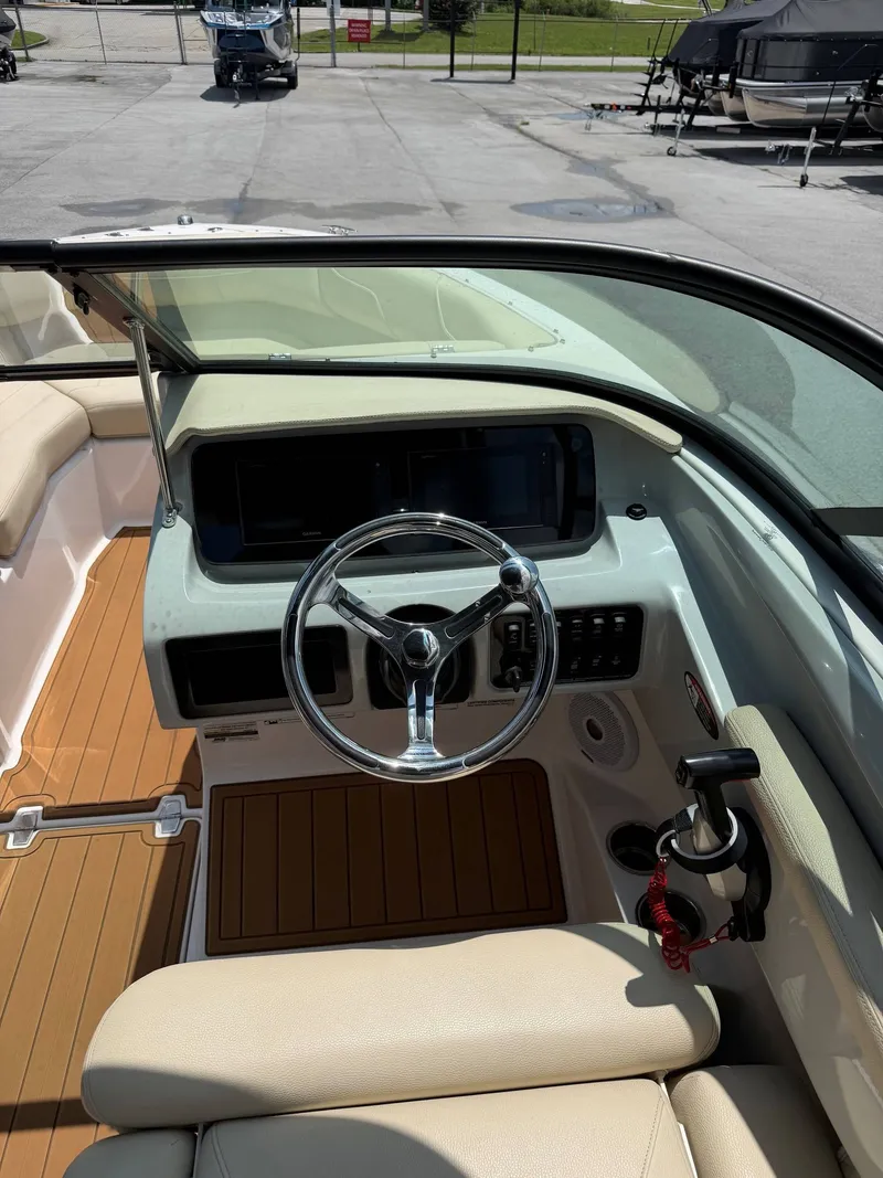 Slide: The Image of The image shows the cockpit of a 2021 Regal LX2 boat with a sleek steering wheel and modern instruments. - 11