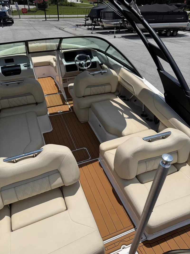 Slide: The Image of The image shows the interior of a 2021 Regal LX2 boat with beige seating and wood flooring. - 6