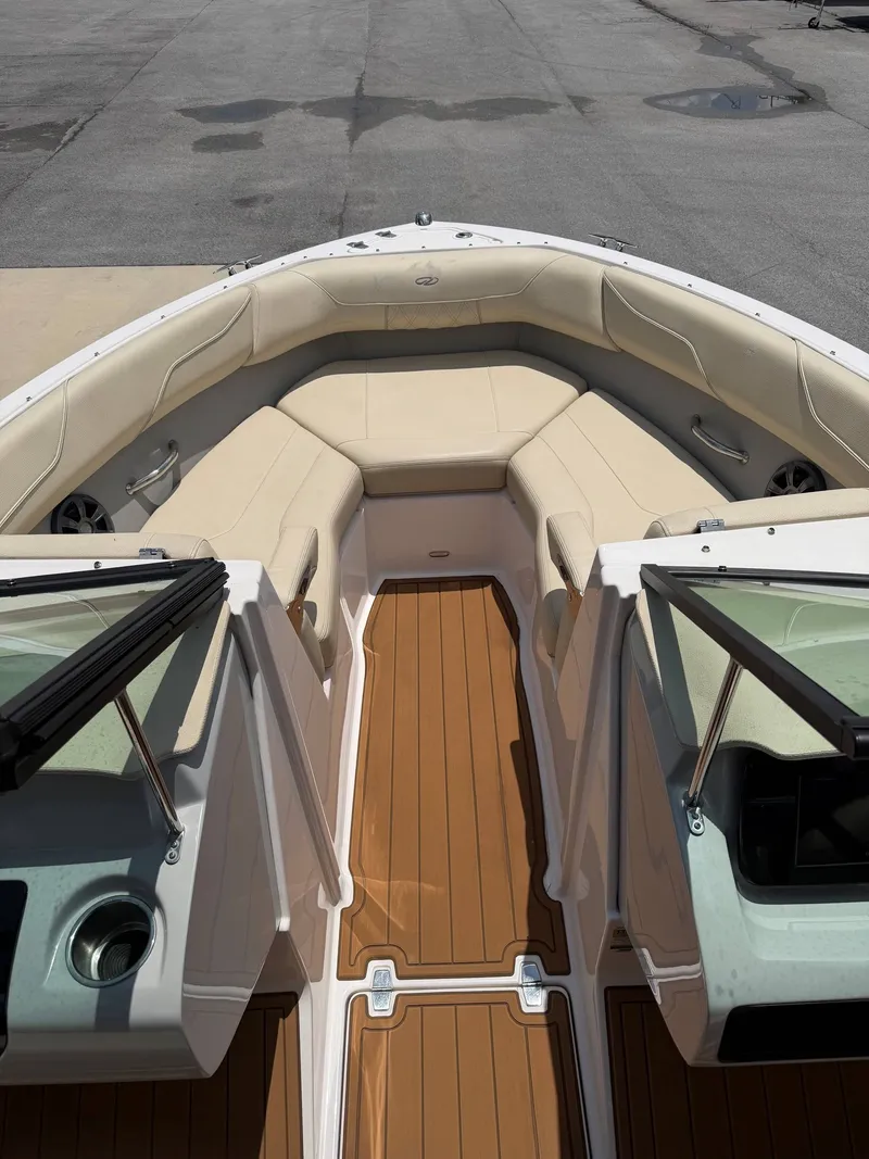 Slide: The Image of The image shows the bow of a 2021 Regal LX2 boat with beige upholstery. - 8