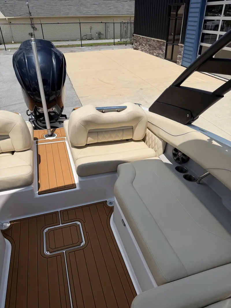 Slide: The Image of The image shows the cockpit of a 2021 Regal LX2 boat with beige seating and wood flooring. - 5