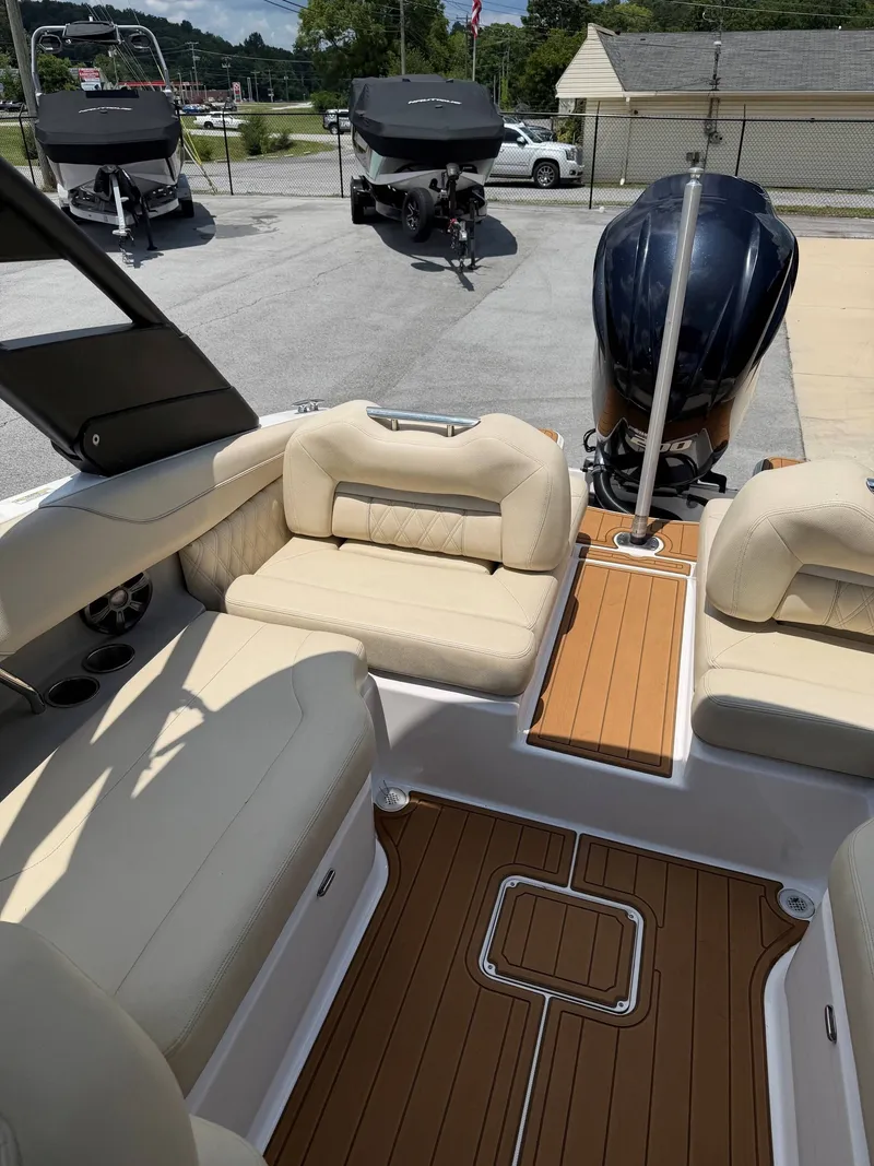 Slide: The Image of The image shows the cockpit of a 2021 Regal LX2 boat with beige seats and wood flooring. - 9