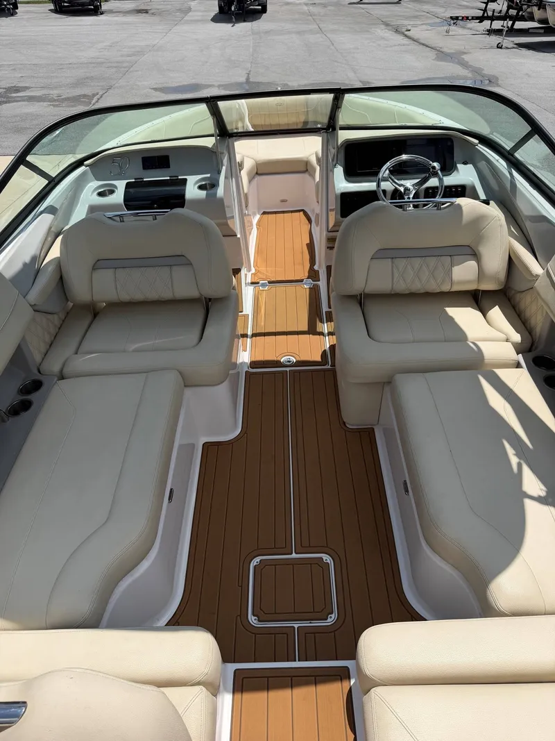 Slide: The Image of The image shows the interior of a 2021 Regal LX2 boat with beige seating and wood flooring. - 4