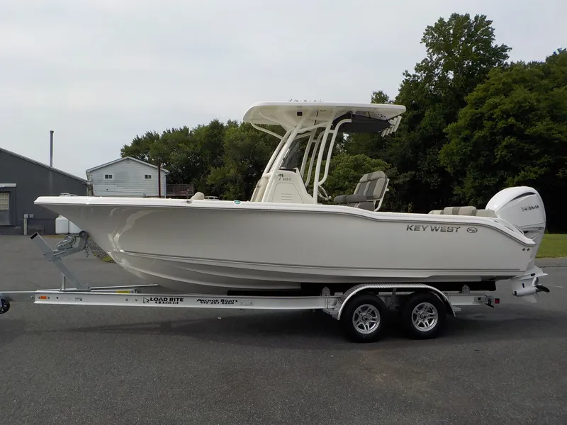 Slide: The Image of A 2027 Key West 239 FS boat on a trailer, parked on a paved lot. - 4