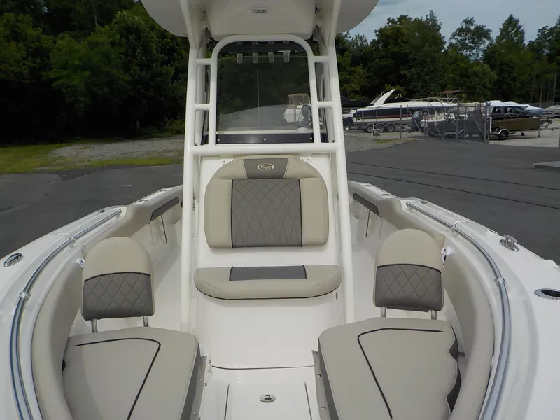 Slide: The Image of The image shows the cockpit of a Key West 239 FS boat with beige upholstery and a clear sky. - 11