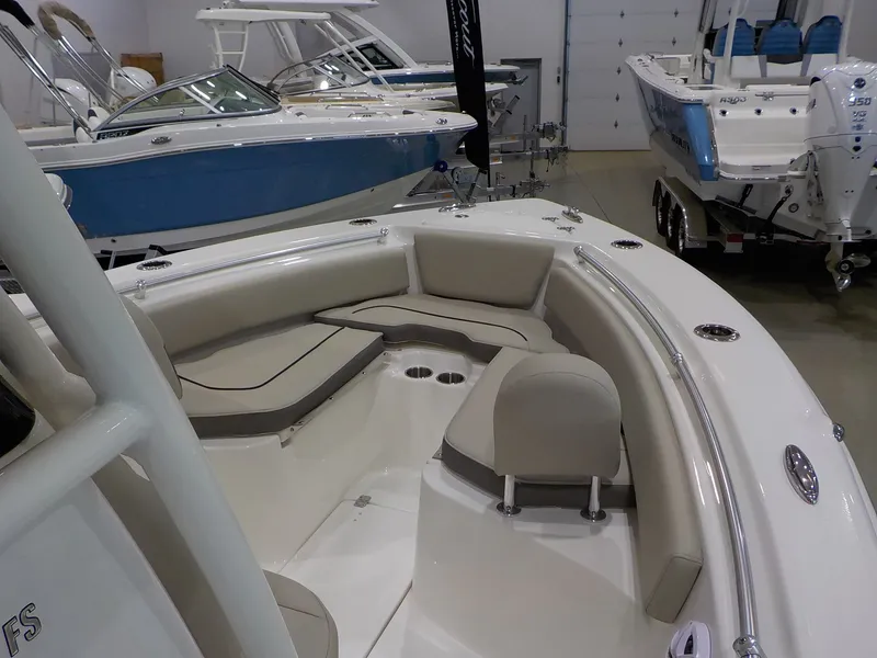 Slide: The Image of The image shows the bow area of a Key West 239 FS boat with beige cushions. - 16