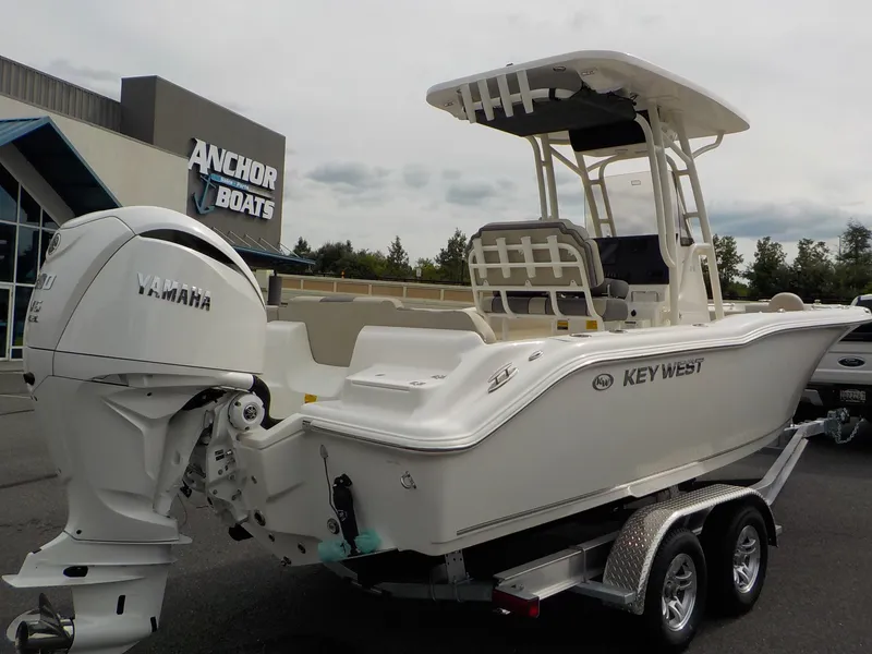 Slide: The Image of A 2027 Key West 239 FS boat on a trailer in front of an Anchor Boats building. - 7