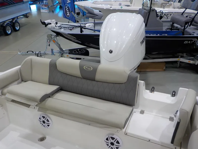 Slide: The Image of The image shows the stern of a Key West 239 FS boat with gray upholstery and speakers. - 14