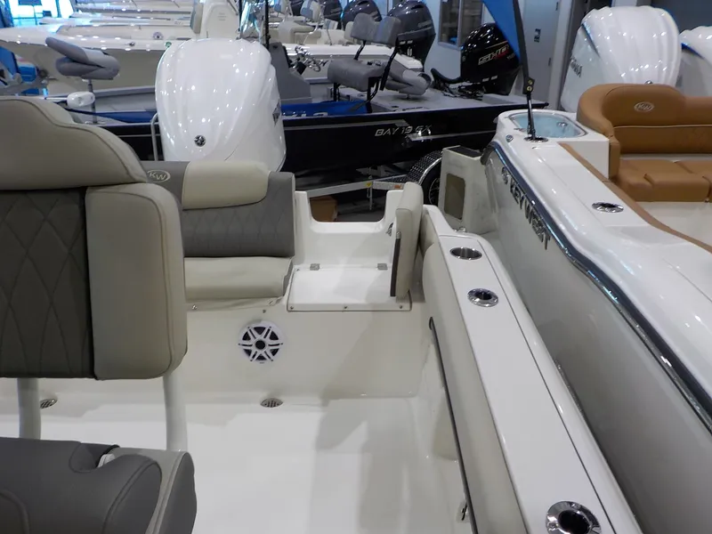 Slide: The Image of The image shows the interior of a Key West 239 FS boat with cushioned seating and an engine. - 12
