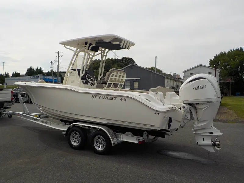Slide: The Image of A 2027 Key West 239 FS boat on a trailer, featuring a Yamaha outboard motor. - 6