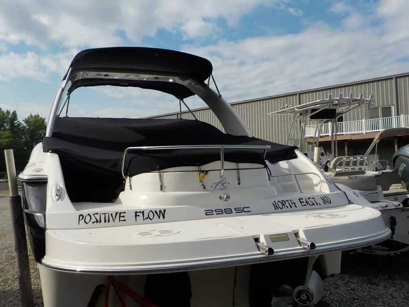 Slide: The Image of A white 2006 Monterey 298SC Super Sport boat is on dry dock under a cloudy sky. - 5