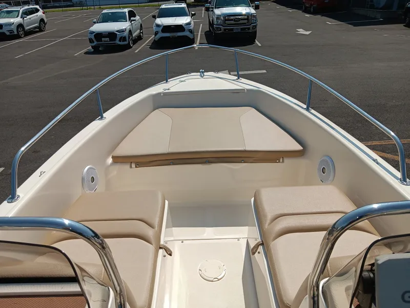 Slide: The Image of The image shows the bow of a 2020 Scout 175 Sport Dorado boat with beige cushions. - 6