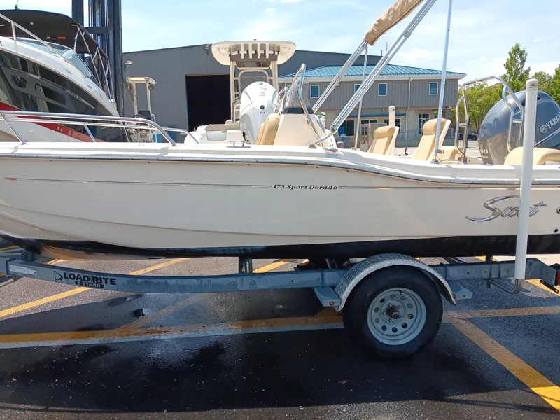 Slide: The Image of A 2020 Scout 175 Sport Dorado boat on a trailer, parked in front of a building. - 18