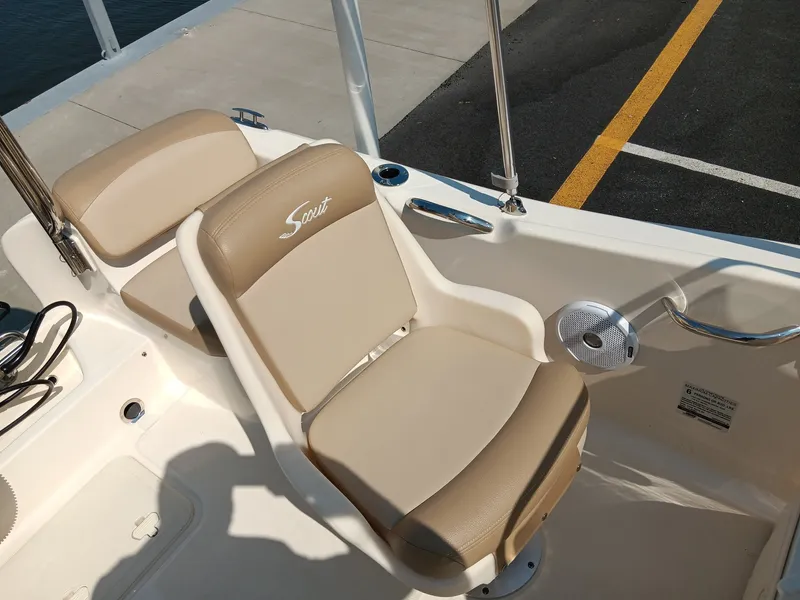 Slide: The Image of Two beige cushioned seats on a boat, with Scout logo on one seat. - 5