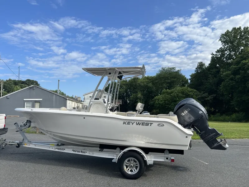 Slide: The Image of A 2027 Key West 203 FS boat on a trailer, featuring an outboard motor and T-top. - 3