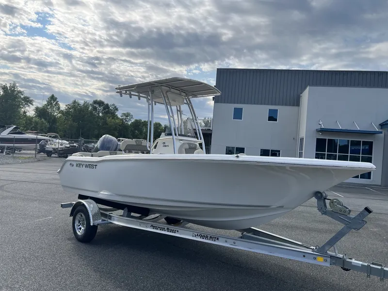 Slide: The Image of A white Key West 203 FS boat from 2027 on a trailer in front of a building. - 4