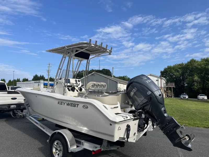 Slide: The Image of A 2027 Key West 203 FS boat on a trailer, featuring a large outboard motor. - 2