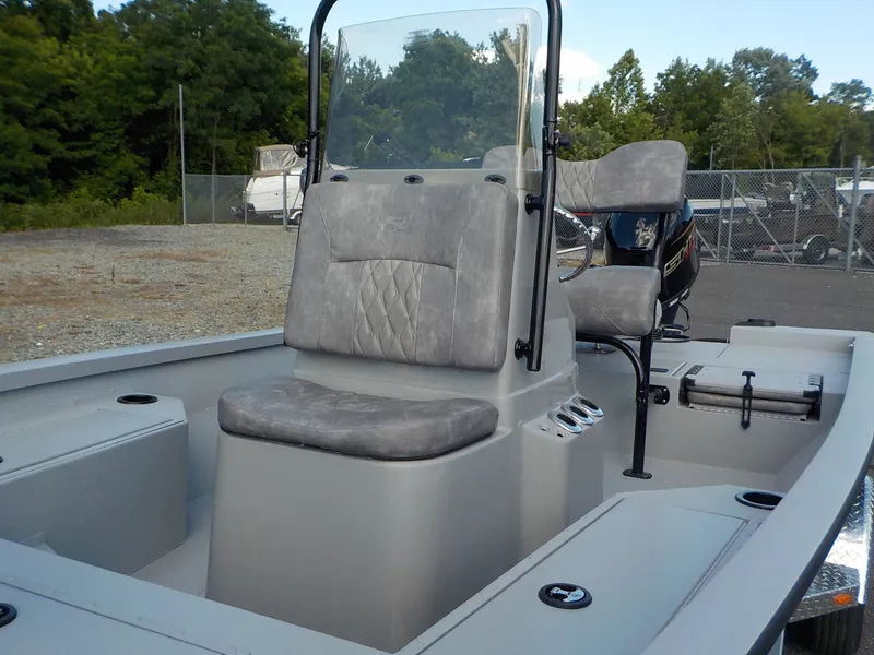 Slide: The Image of The image shows a gray G3 Bay 19 GX boat with cushioned seats and a steering console. - 11
