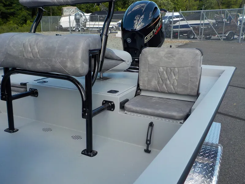Slide: The Image of The image shows the gray interior of a G3 Bay 19 GX boat with cushioned seats and an outboard motor. - 12