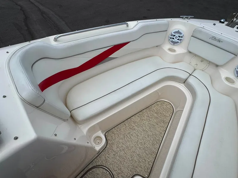 Slide: The Image of The image shows the white upholstery of a 2006 Rinker 282 BR with red accents. - 10
