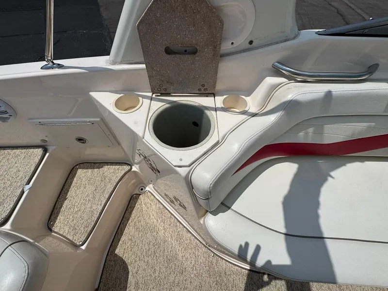 Slide: The Image of The image shows the interior of a 2006 Rinker 282 BR boat with beige seating and carpeted flooring. - 5