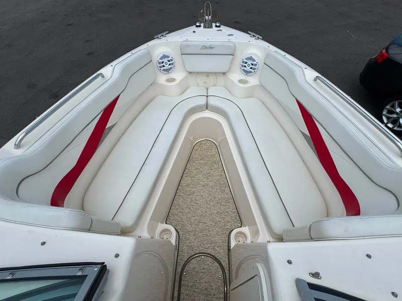 Slide: The Image of The image shows the bow area of a 2006 Rinker 282 BR boat with white and red seating. - 15