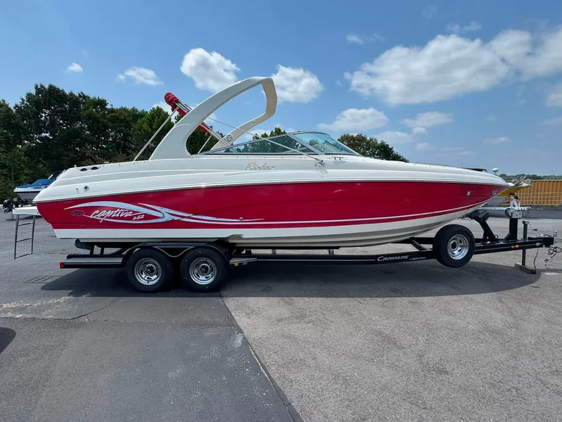 The Image of A red 2006 Rinker 282 BR boat on a trailer, ready for the water. - 1