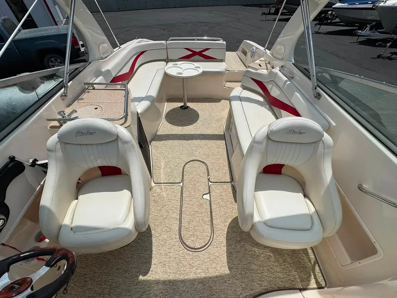 Slide: The Image of The image shows the cockpit of a 2006 Rinker 282 BR with white seats and red accents. - 9