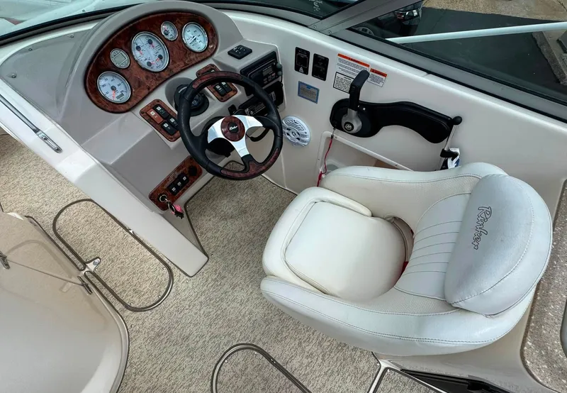 Slide: The Image of The image shows the cockpit of a 2006 Rinker 282 BR with a sleek helm station. - 7