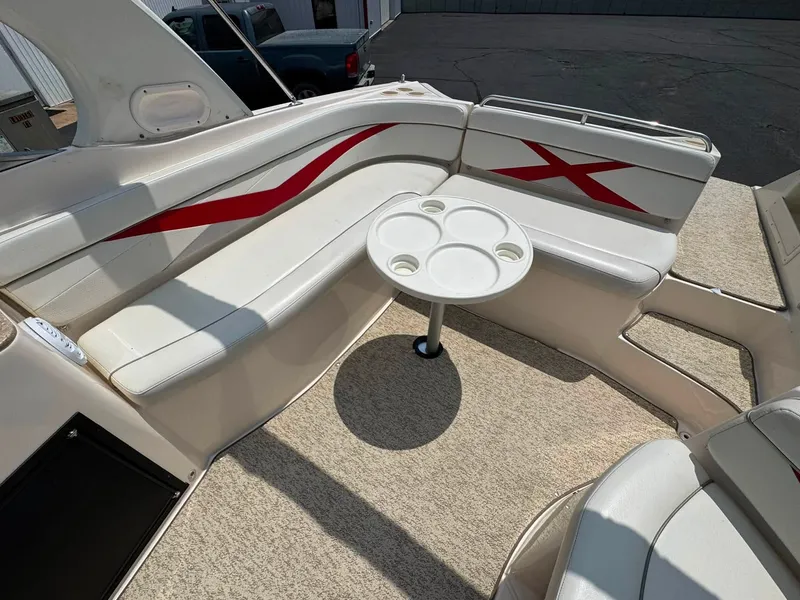 Slide: The Image of The image shows the cockpit of a 2006 Rinker 282 BR boat with white seating and red accents. - 6