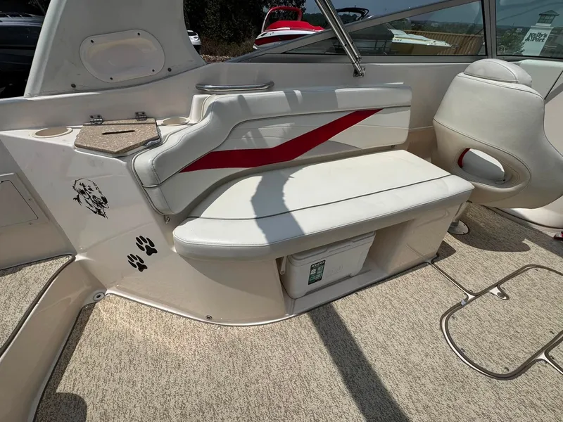 Slide: The Image of The image shows the cockpit of a 2006 Rinker 282 BR with white seats and red accents. - 13