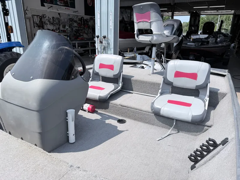 Slide: The Image of The image shows the cockpit of a 2011 Tracker Pro 165 boat with gray and red seats. - 25