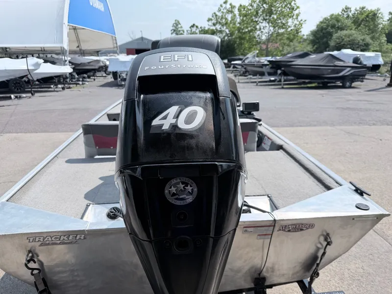 Slide: The Image of A 2011 Tracker Pro 165 boat with a 40 HP EFI four-stroke engine, parked outdoors. - 5