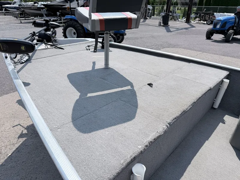 Slide: The Image of The image shows the deck of a 2011 Tracker Pro 165 boat with a seat and rod holders. - 22