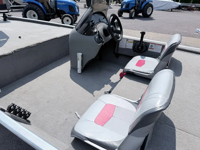 Slide: The Image of The image shows the cockpit of a 2011 Tracker Pro 165 boat with two gray seats. - 21
