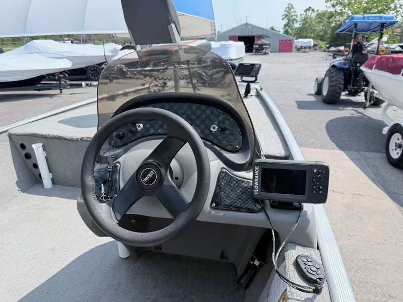 Slide: The Image of The image shows the cockpit of a 2011 Tracker Pro 165 boat with a steering wheel and fish finder. - 4