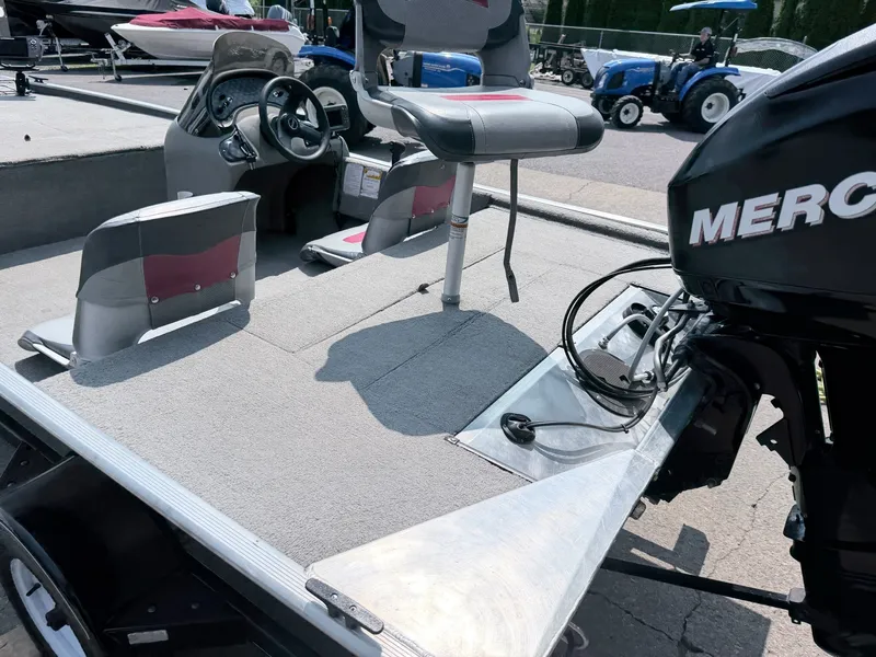 Slide: The Image of The image shows the cockpit of a 2011 Tracker Pro 165 boat with a Mercury engine. - 7