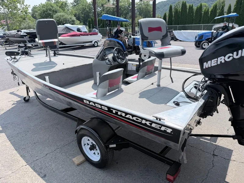 Slide: The Image of A 2011 Tracker Pro 165 boat with gray seats and a Mercury engine, on a trailer. - 26