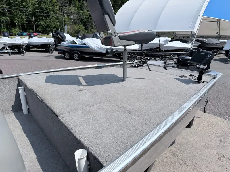 Slide: The Image of A 2011 Tracker Pro 165 with gray carpeting and a mounted seat on the deck. - 19