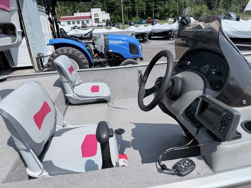 Slide: The Image of The image shows the cockpit of a 2011 Tracker Pro 165 boat with two seats and a helm. - 6