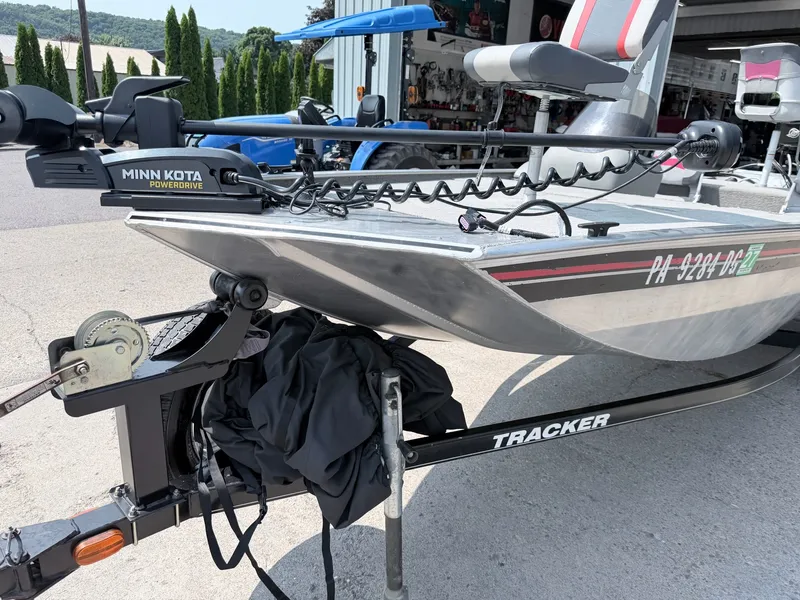 Slide: The Image of A 2011 Tracker Pro 165 boat with Minn Kota PowerDrive motor, parked on a trailer. - 27