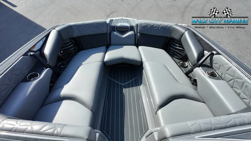 Slide: The Image of The image shows the luxurious gray seating area of the 2022 Nautique Super Air Nautique G25 Paragon. - 27