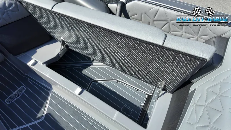 Slide: The Image of The image shows the interior of a 2022 Nautique Super Air Nautique G25 Paragon with a seat lifted. - 29