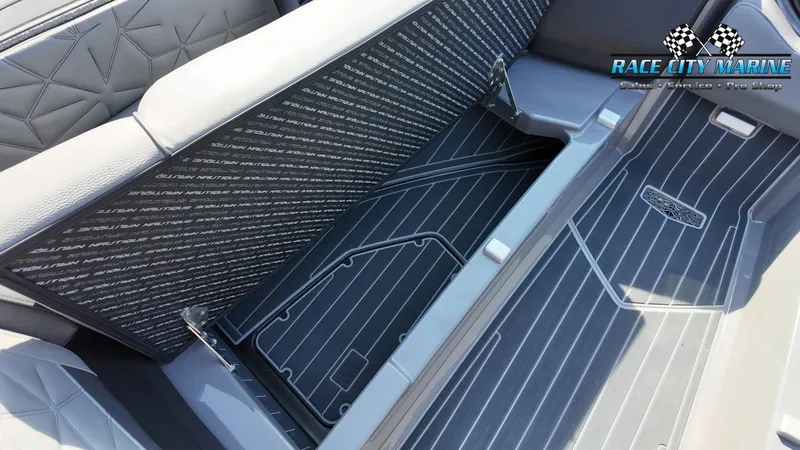 Slide: The Image of The image shows the interior of a 2022 Nautique Super Air Nautique G25 Paragon with gray upholstery and textured flooring. - 30